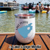 A white insulated tumbler with a Lake Perris California graphic sits on a wooden boat deck.