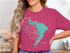 Pink t-shirt with "Beautiful Lake Waco Texas" and compass graphic.