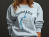 Light blue sweatshirt with Abraham Lake map and compass graphic.
