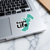 Turquoise map shape sticker with "Eagle Life" text on a laptop.