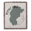 Woven throw blanket with Topaz Lake shape and California compass rose design.