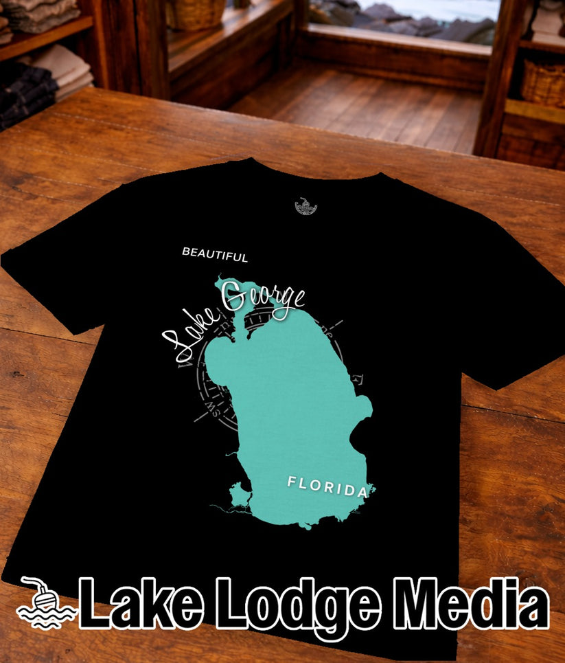 Black t-shirt with turquoise Lake George map and "Lake Lodge Media" logo.