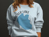 Light blue sweatshirt with a graphic of Hauser Lake, Idaho and compass design.