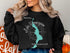 Black sweatshirt with Lake Winnisquam New Hampshire map and compass graphic.