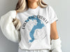 White t-shirt with blue Lake Pend Oreille map graphic and "IDAHO" text.