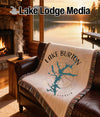 Fringe blanket on leather couch with Lake Burton Georgia map and compass design.