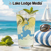 Glass with lake map and compass, garnished with lime and mint, beach background.