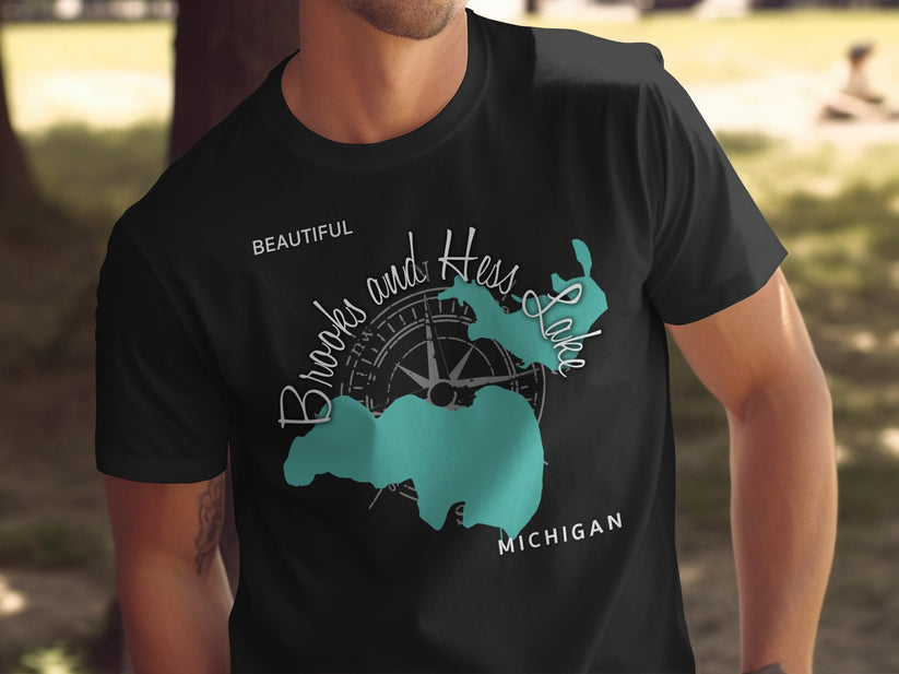 Black t-shirt with compass and teal outline of Brooks and Hess Lake, Michigan.