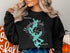 Black sweatshirt with "Beautiful Moosehead Lake Maine" map graphic.