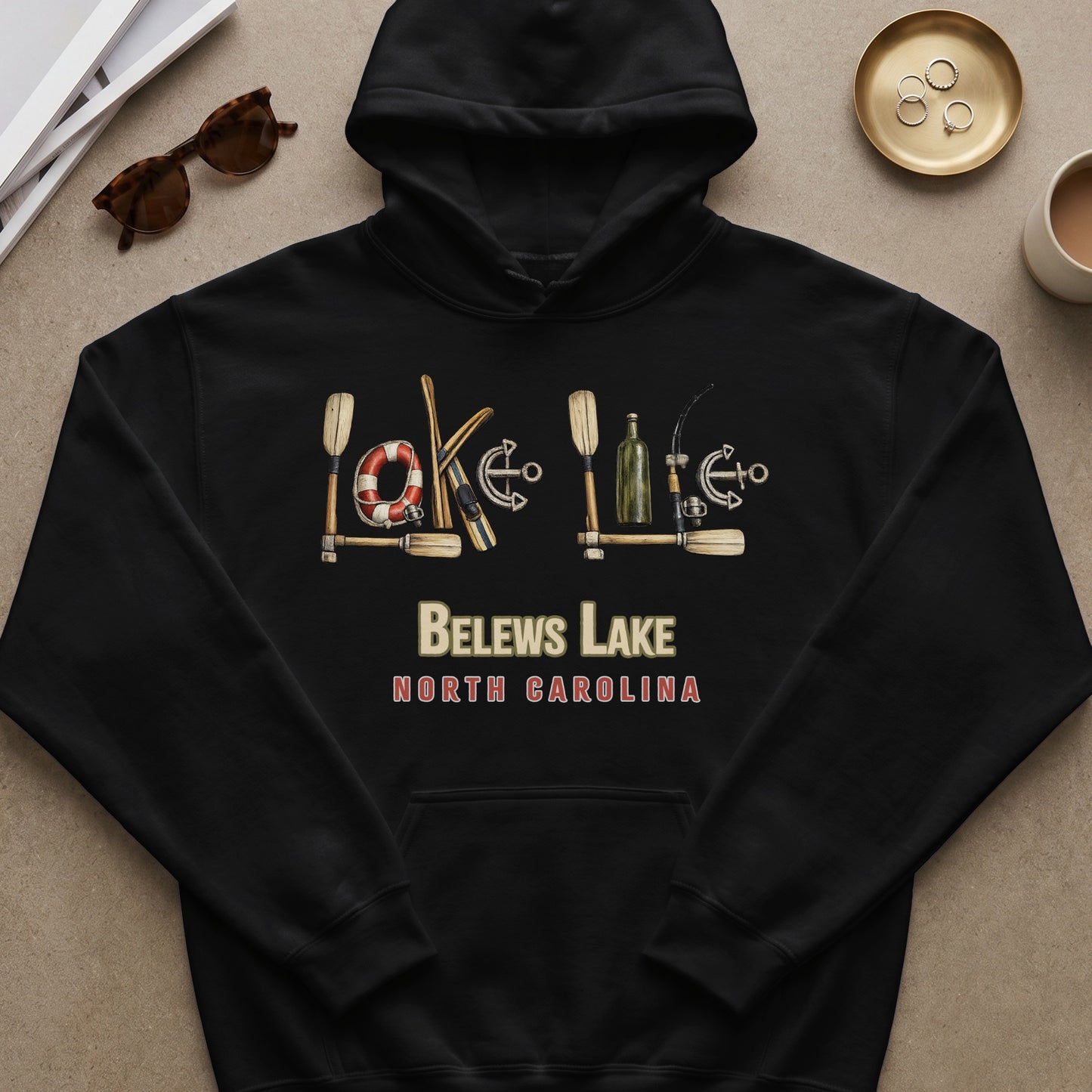 Black hoodie with "BELEWS LAKE" and "NORTH CAROLINA" text, featuring lake-themed icons.