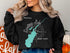 Black sweatshirt with Saratoga Lake map and compass graphic.