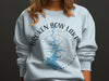 Light blue sweatshirt with "Broken Bow Lake Oklahoma" map and compass graphic.