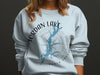 Light blue sweatshirt with Jordan Lake map and compass design.
