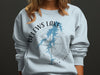 Light blue sweatshirt with Belew's Lake map and compass design, North Carolina.