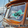 Turquoise Mascuppic Life sticker on a boat window with "Lake Lodge Media" text.