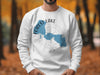 White sweatshirt with blue Forest Lake, Minnesota map graphic and compass design.