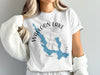 White t-shirt with blue Walloon Lake map and compass graphic.