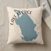 Light beige pillow with blue Lake George map graphic and text.
