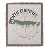 Woven blanket featuring a compass rose, North Channel Michigan outline, and text.