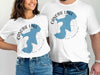 White t-shirts featuring a blue outline of Canobie Lake, New Hampshire over a compass rose.