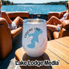 A white stainless steel wine tumbler with a Canobie Lake New Hampshire graphic sits on a boat table.