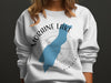 White sweatshirt with "Moraine Lake Alberta" text and blue lake silhouette.