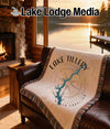 Woven blanket featuring "Lake Tillery North Carolina" map graphic on a couch.