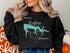 Black sweatshirt with "Lake Rayburn Arkansas" and compass graphic.