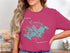 Pink t-shirt featuring a turquoise map and compass of Lake Minnetonka, Minnesota.