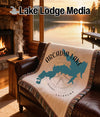 Blanket with Arcadia Lake and Oklahoma map design on a leather couch.