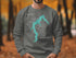 Sweatshirt featuring a teal outline of Lake Jacomo and a compass rose.