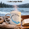 White mug with "Sanibel Island Florida" and compass design beside a book.
