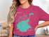 Teal outline of Timothy Lake, Oregon on a pink t-shirt.