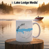 White mug with Enid Lake map and compass design on a misty lake background.
