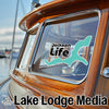Turquoise Jackson Life logo on boat window with Lake Lodge Media text below.