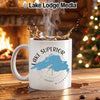 White mug with Lake Superior map and compass design, steaming coffee.