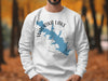 White sweatshirt with blue "Waurika Lake Oklahoma" map graphic and compass rose.