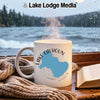 White mug with "Lake Calhoun Georgia" graphic on a cozy windowsill.