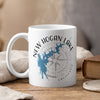 White mug with New Hogan Lake map and compass design, California.