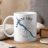 White mug with "Maligne Lake Canada" text and lake silhouette over compass.