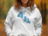 White hoodie with blue Clearwater Lake, Minnesota map and compass graphic.