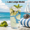 Glass with Nantahala Lake map, ice, lime, and mint on beach background.