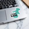 Turquoise sticker with "Canobie Life" text on a laptop keyboard.