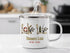 White enamel mug with "Honeoye Lake NEW YORK" and lake-themed graphics.