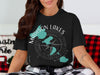 Black t-shirt with "Madison Lakes Wisconsin" text and compass graphic.