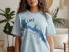 Light blue t-shirt featuring a blue Bass Lake outline over a compass graphic with California text.