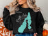 Black sweatshirt with a teal map outline of Payette Lake, Idaho and compass rose.