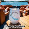 A white insulated tumbler with Sanibel Island, Florida graphics rests on a wooden boat table.