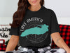 Black t-shirt with a turquoise map of Lake Michigan and compass graphic.