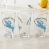 Three clear glasses feature blue Lake Winnipesaukee maps and compass details.